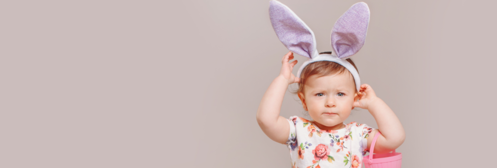 Image of a little girl wearing - a headband with easter ears